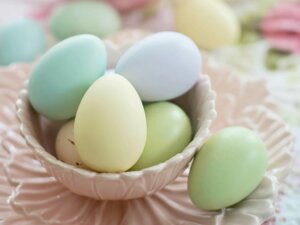 Ostereier in Pastellfarben liegen in einem kleinen Körbchen